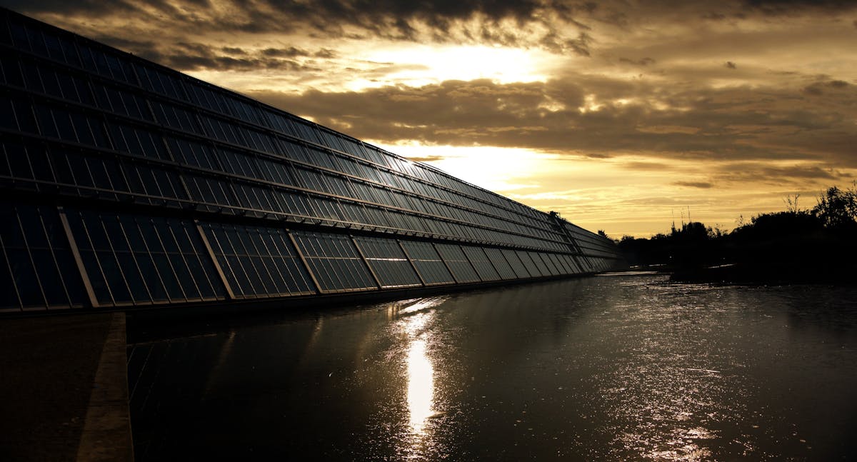 Black Solar Panel Near Calm Body of Water